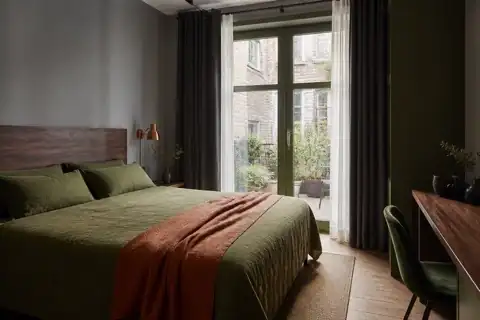 Courtyard hotel room with olive linen